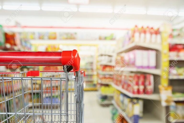 108119993 convenience store shelves interior blur background with empty supermarket shopping cart 1 768x512