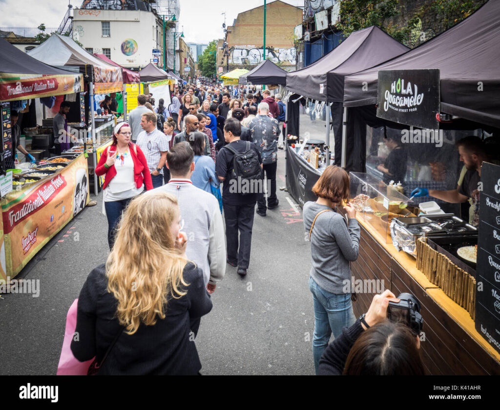brick lane sunday food market tourists locals browse the street food K41AHR 1 1024x839