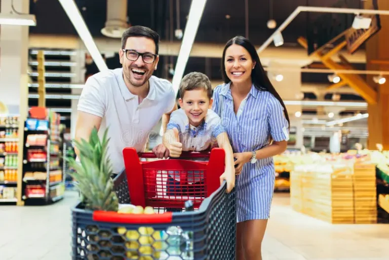 happy family child shopping cart buying food grocery store supermarket happy family child shopping cart 153046281 768x513