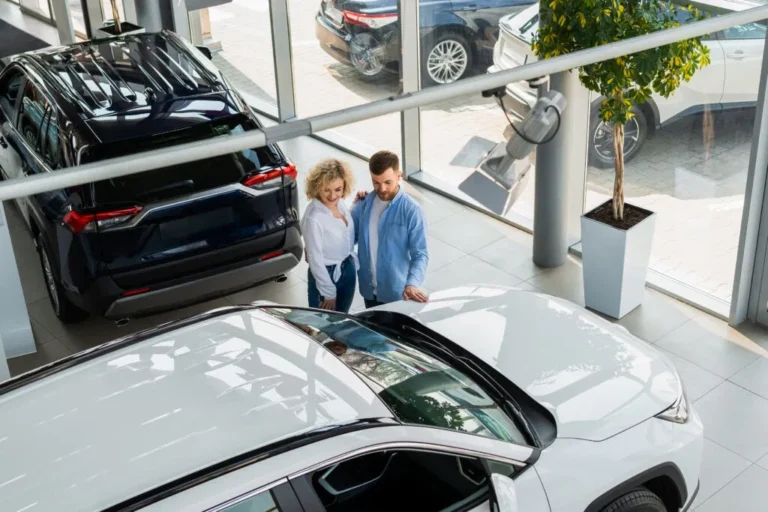 man and woman in a car dealership top view couple 2024 10 21 04 18 20 utc 1024x683 1 768x512