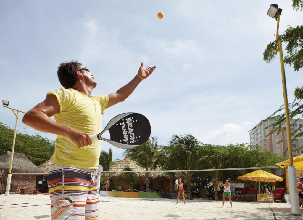 Aruba Beach Tennis  Man Serving at Moomba Courts 0 1024x742