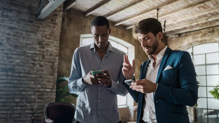 HeroImageTwoProfessionalsOnSmartphonesinHipsterOffice 768x432