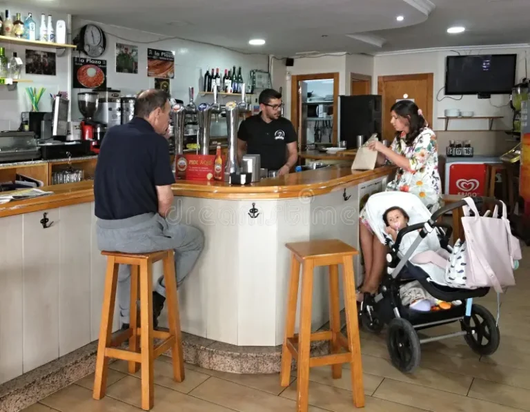 woman baby stroller man bar counter customers enjoying casual moment local bartender serving 438283005 768x597